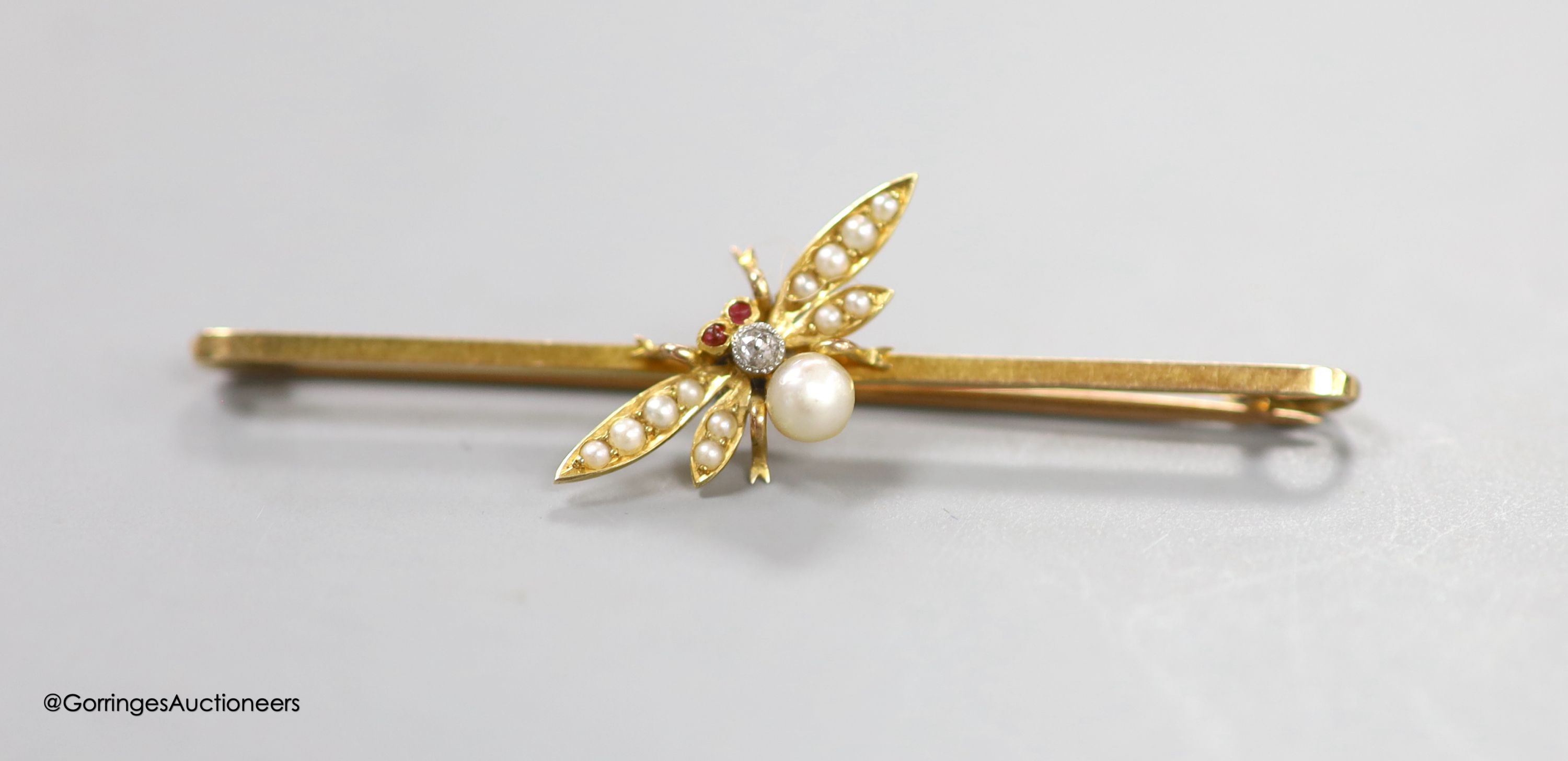An Edwardian 15ct, diamond and seed pearl set bug bar brooch, with cabochon eyes, 53mm, gross 3.3. grams.